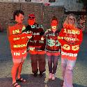 Four people standing with a projector shining on them displaying words