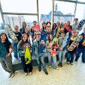 A group of people holding snowboards