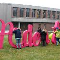 Students assemble the word Ardent, made from cardboard outside of Haynes Hall. 