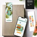 A book app on a phone screen placed on top of a book with a bookmark beside it