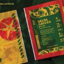 Two books opened to stylized recipe pages for salsa. The pages are yellow, green and red on a black background
