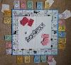 Monopoly board & pieces, charm figurines, cardstock, acrylic paint.