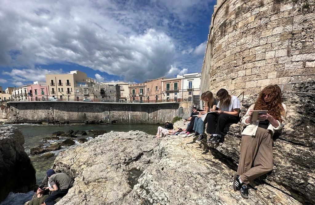 Students studying outside on the Italian coast